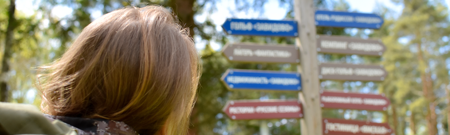 A woman with wayfinding signage